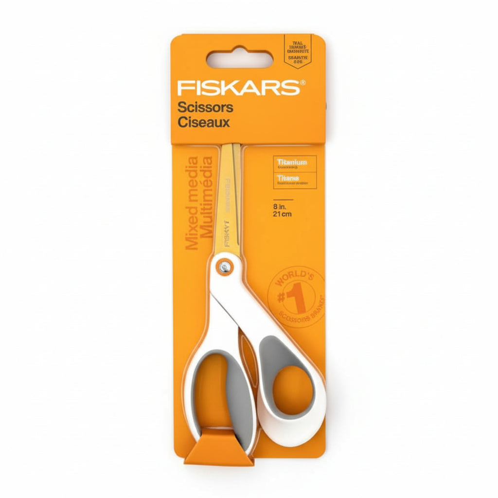 Packaged Fiskars 8in Soft Grip Titanium Scissors with white and gray handles on an orange background.