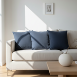 Modern living room with a white sofa, blue cushions, and a wooden coffee table.