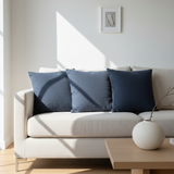 Modern living room with a white sofa, blue cushions, and a wooden coffee table.