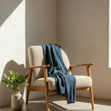 Chair with a blue blanket draped over it in a sunlit room
