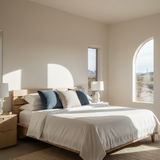 Modern bedroom with a bed, nightstands, and large windows.