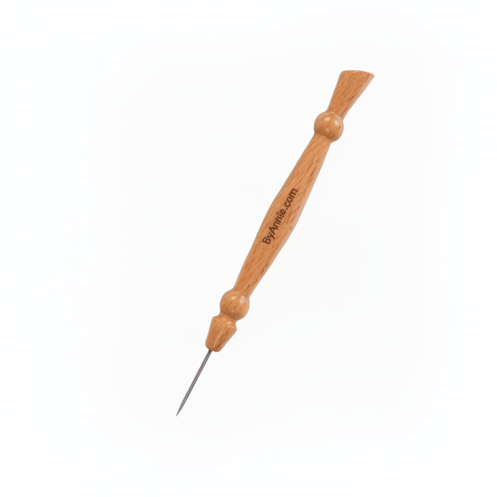 Wooden needle tool with a metal tip on a white background