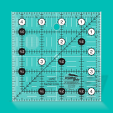 Quilting ruler with measurements on a teal background