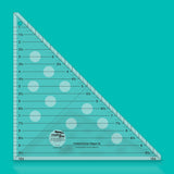 Clear triangular ruler with measurement markings on a teal background