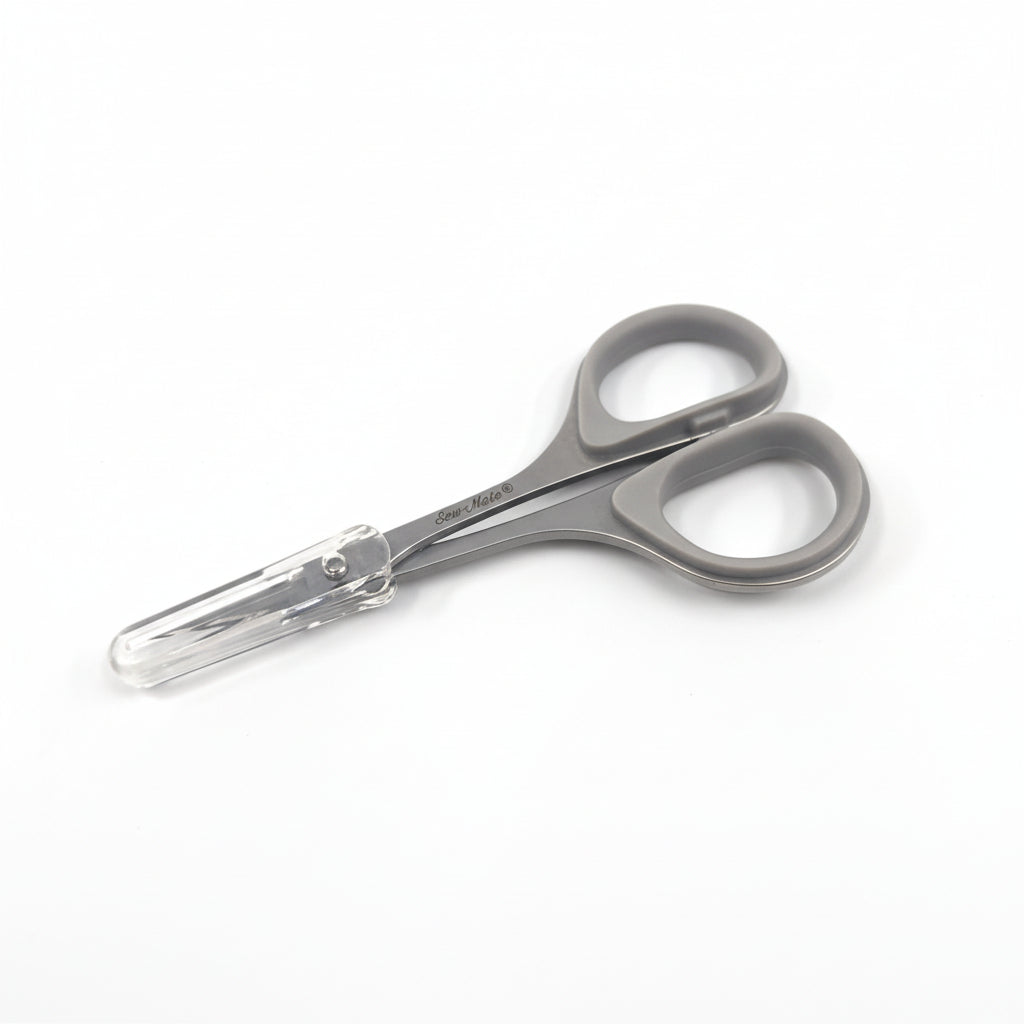 Pair of gray baby scissors on a white background