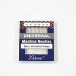 Pack of Klasse universal machine needles with assorted sizes on a white background