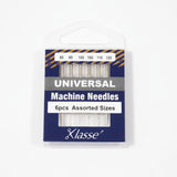 Pack of Klasse universal machine needles with assorted sizes on a white background