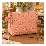 Quilted accent pillow featuring Ladybug Whimsy Zinnias Black fabric with large coral, pink, cream and golden flowers by Gingiber for Moda.