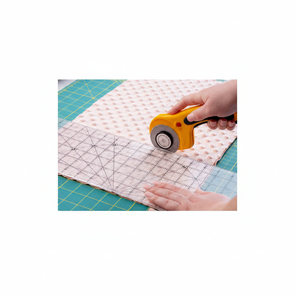 OLFA 60mm Rotary Cutter on a fabric cutting mat