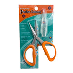Pair of scissors with orange handles in packaging on a white background