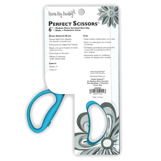 Blue scissors with packaging featuring text and floral design on a white background