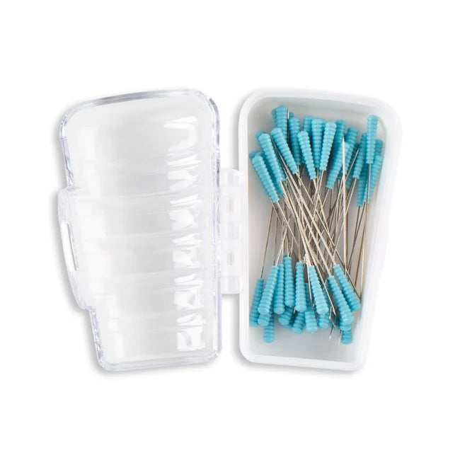 Clear plastic case with turquoise dental tools inside on a white background