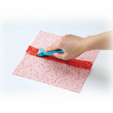 Roll and press being used on a piece of fabric