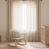 Fabric decorated with a pattern of small suns decorating a child's nursery.
