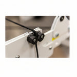 Close-up of a mechanical component with black connectors on a blurred background