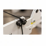 Close-up of a mechanical component with black connectors on a blurred background