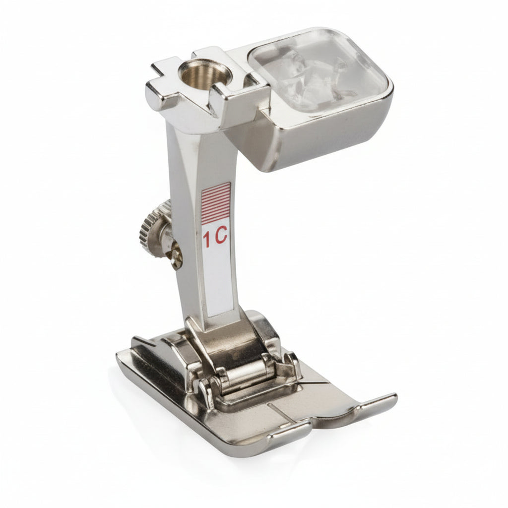 A sewing machine foot accessory, primarily metallic in color, with some parts in a silver finish.